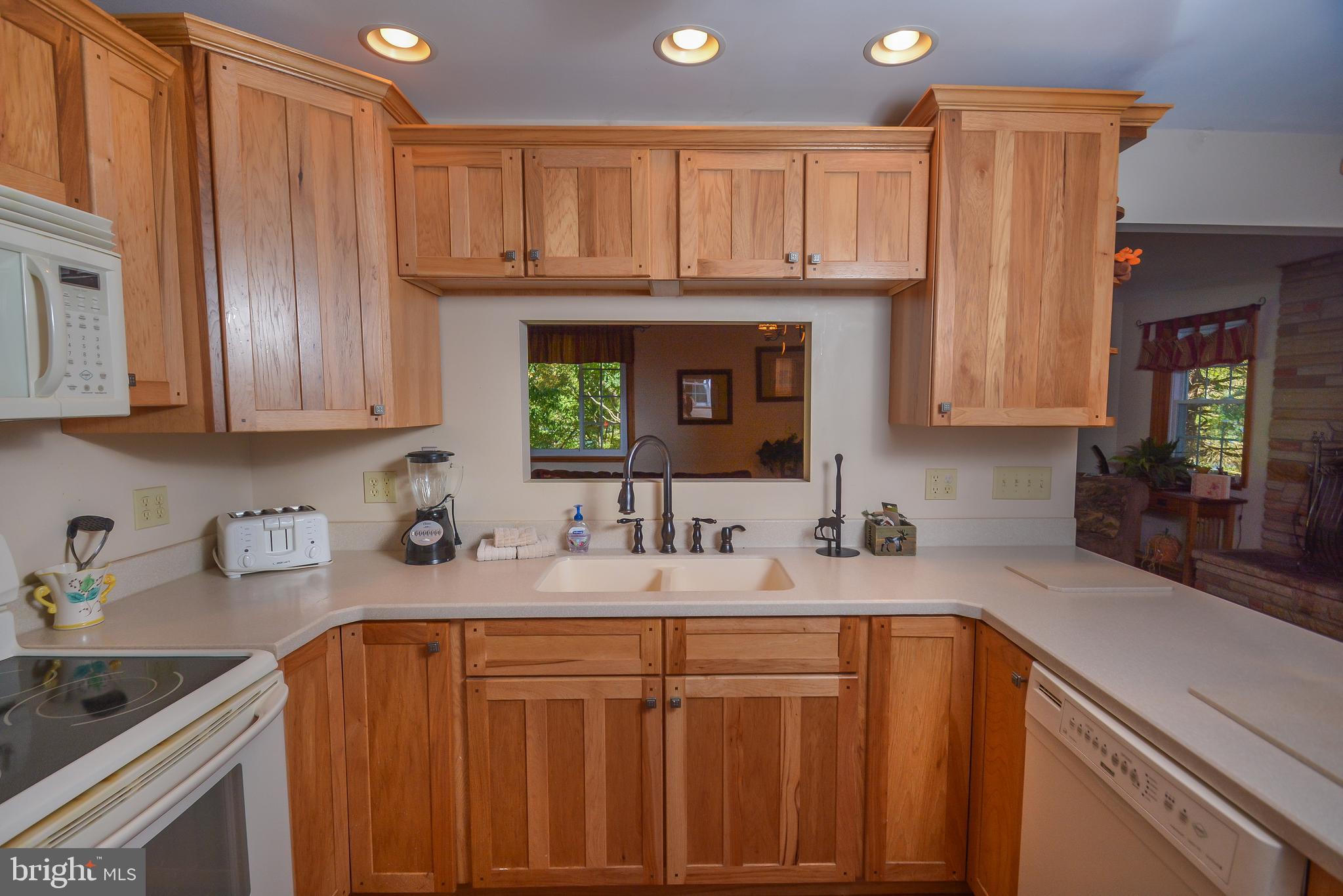 1417 Marsh Hill Road McHenry, MD 21541 - Photo 7 of 34 a kitchen with stainless steel appliances granite countertop a sink refrigerator and cabinets