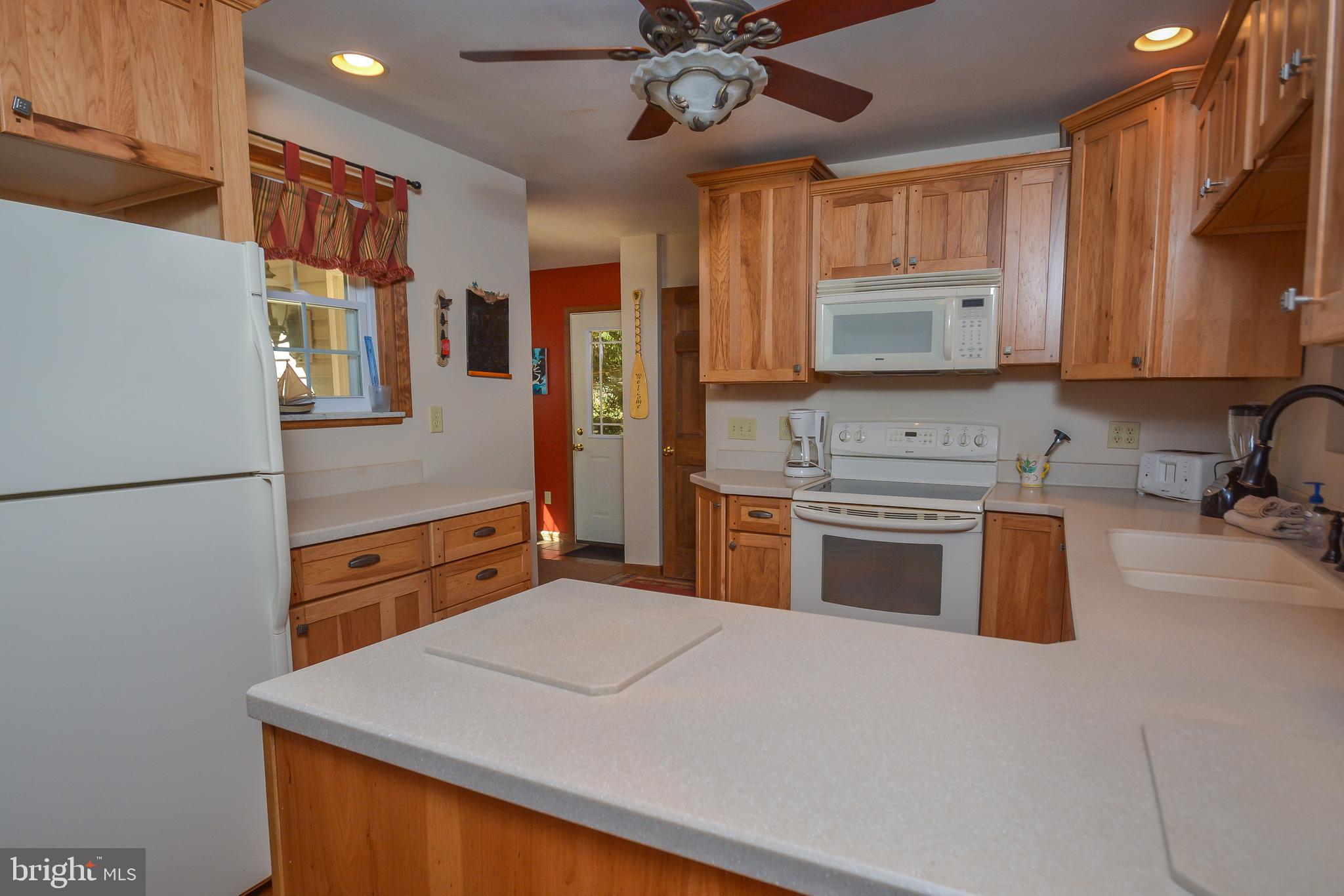 1417 Marsh Hill Road McHenry, MD 21541 - Photo 10 of 34 a kitchen with stainless steel appliances a stove sink and microwave