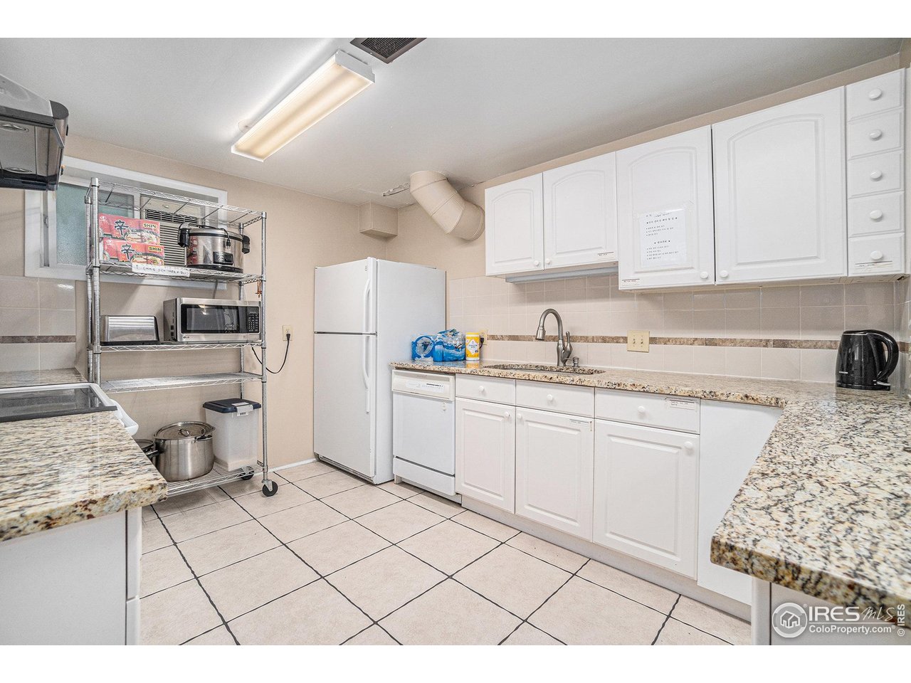 601 South Whitcomb Street Fort Collins, CO 80521 - Photo 17 of 34 a kitchen with a sink a stove a refrigerator and cabinets