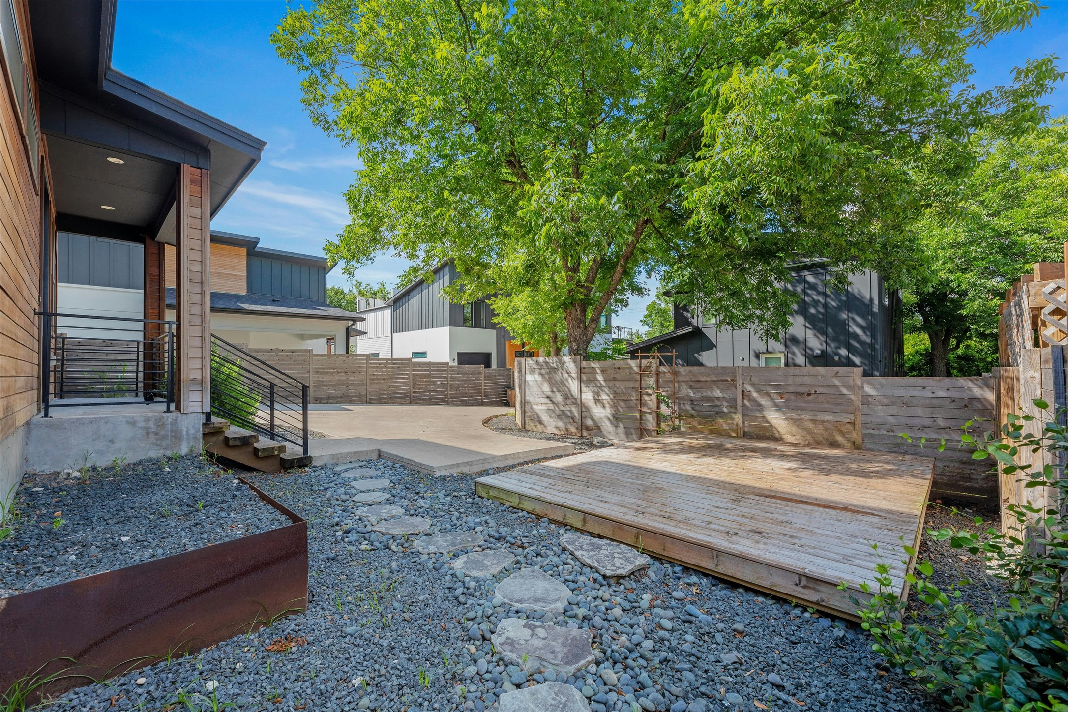 4606 Ledesma Road, Unit 2 Austin, TX 78721 - Photo 31 of 33 A private outdoor space with a wooden deck and gravel landscaping offers tranquil relaxation.