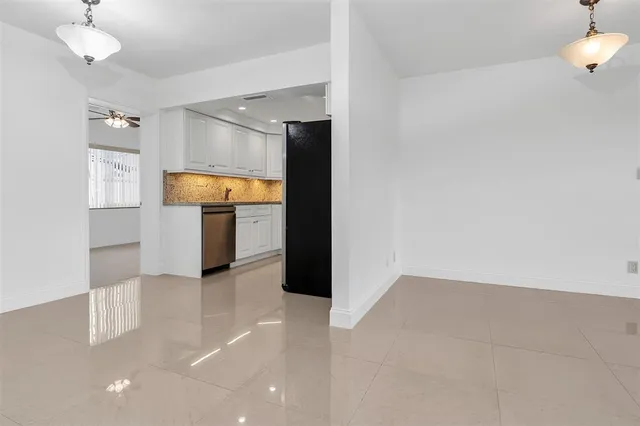 a kitchen with cabinets and refrigerator
