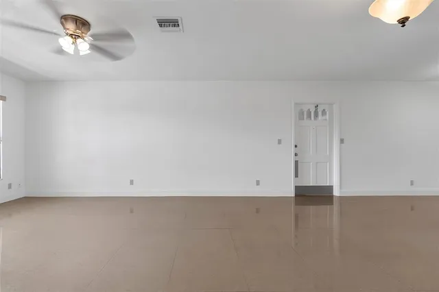 an empty room with a empty space and a ceiling fan