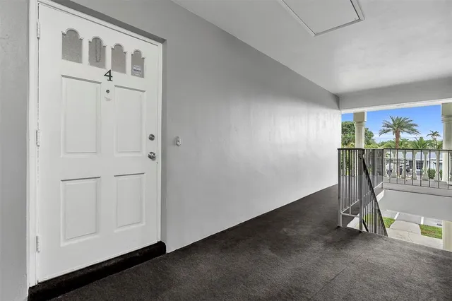 a view of a livingroom with furniture and floor to ceiling window