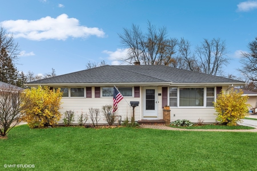 a front view of a house with a garden