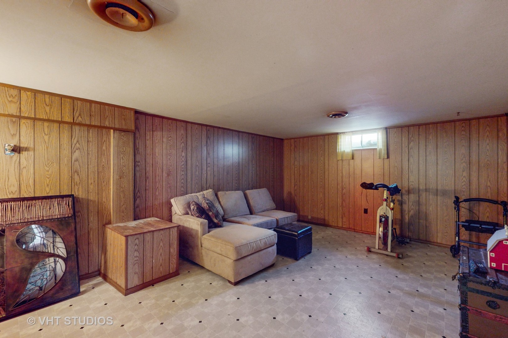 223 Highland Road Grayslake, IL 60030 - Photo 16 of 23 a living room with furniture a fireplace and gym equipment