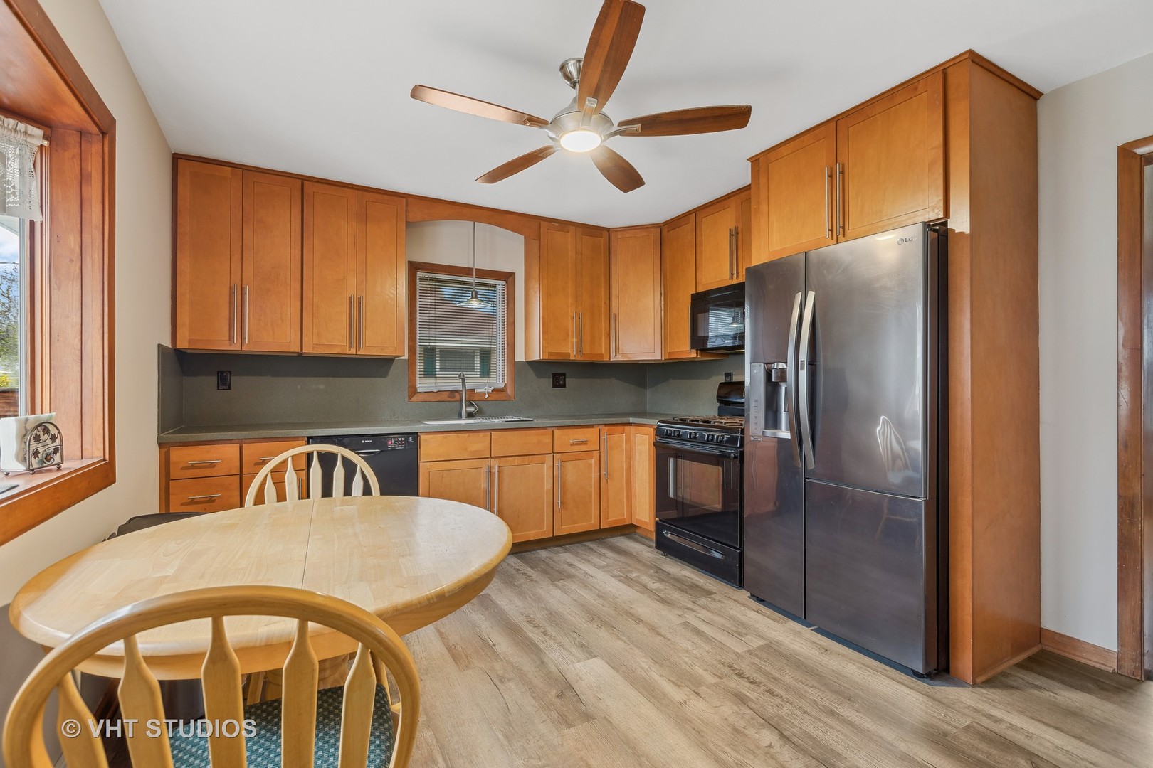 223 Highland Road Grayslake, IL 60030 - Photo 3 of 23 a kitchen with stainless steel appliances granite countertop a refrigerator a stove and a sink with wooden floor