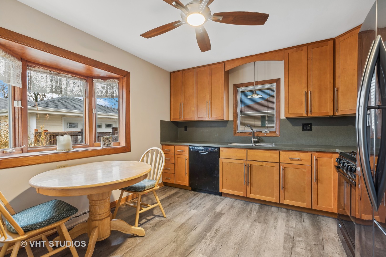 223 Highland Road Grayslake, IL 60030 - Photo 4 of 23 a kitchen with granite countertop wooden floors and white appliances