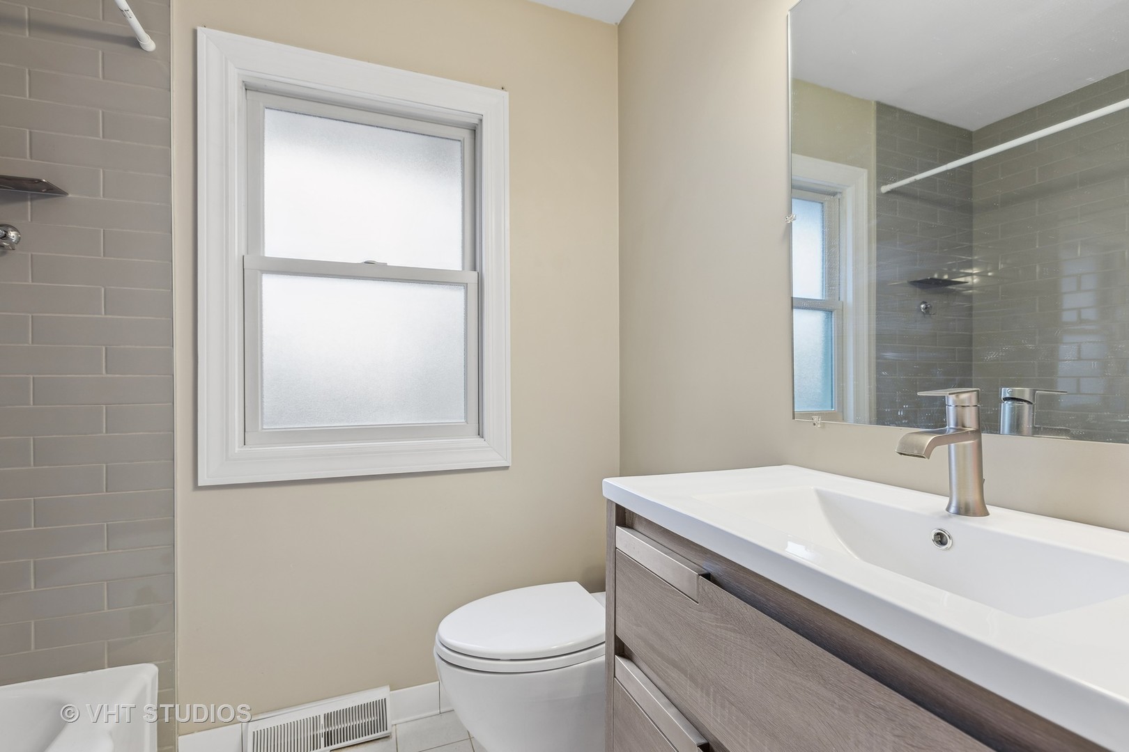 223 Highland Road Grayslake, IL 60030 - Photo 9 of 23 a bathroom with a sink toilet and vanity