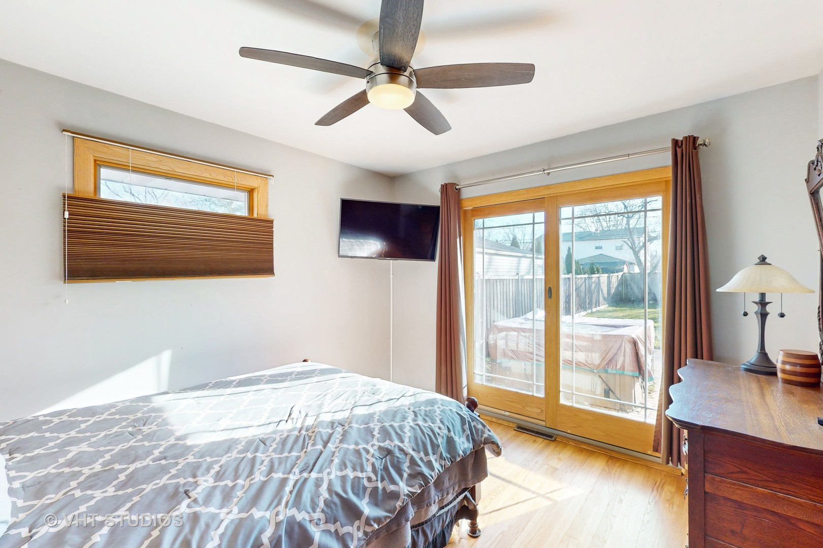 223 Highland Road Grayslake, IL 60030 - Photo 10 of 23 a bedroom with a large bed and a flat tv screen on dresser