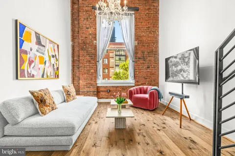 a living room with furniture and wall paintings