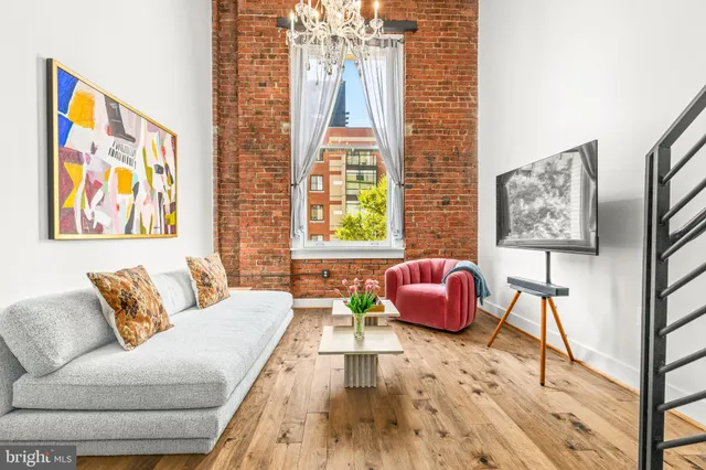 a living room with furniture and wall paintings