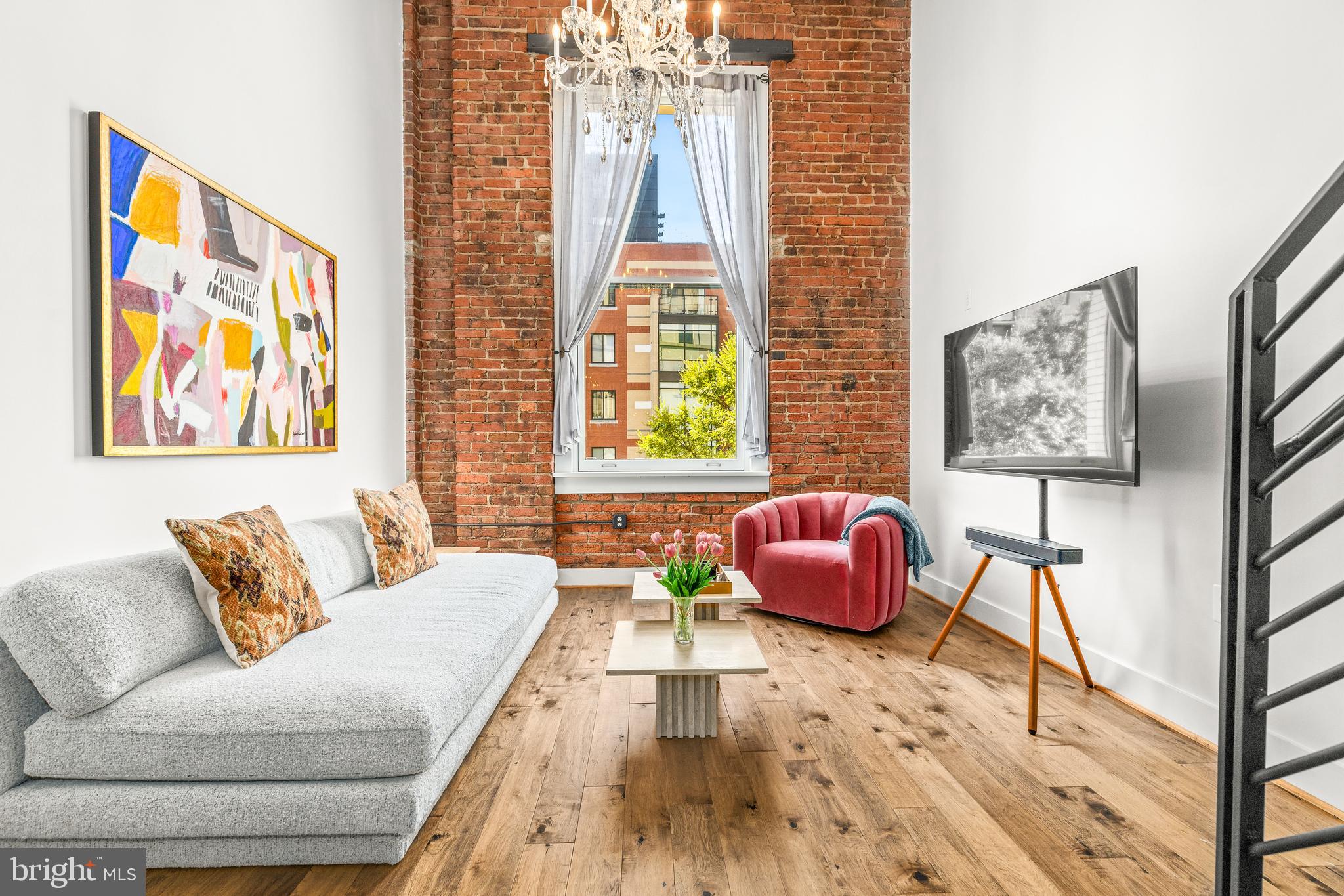 a living room with furniture and wall paintings