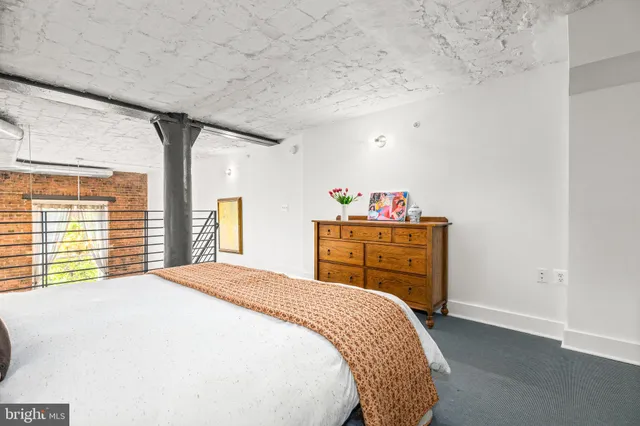 a bed sitting in a bedroom next to a window