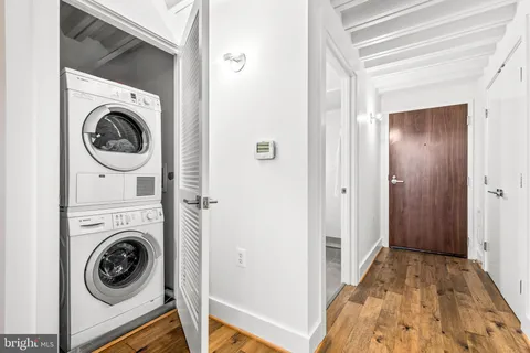 a view of a hallway with washer and dryer