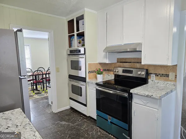 a kitchen with a sink stove and refrigerator