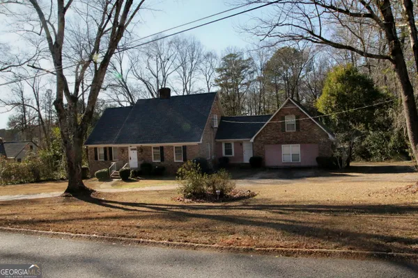 a view of a house with a yard covered with snow in front of house