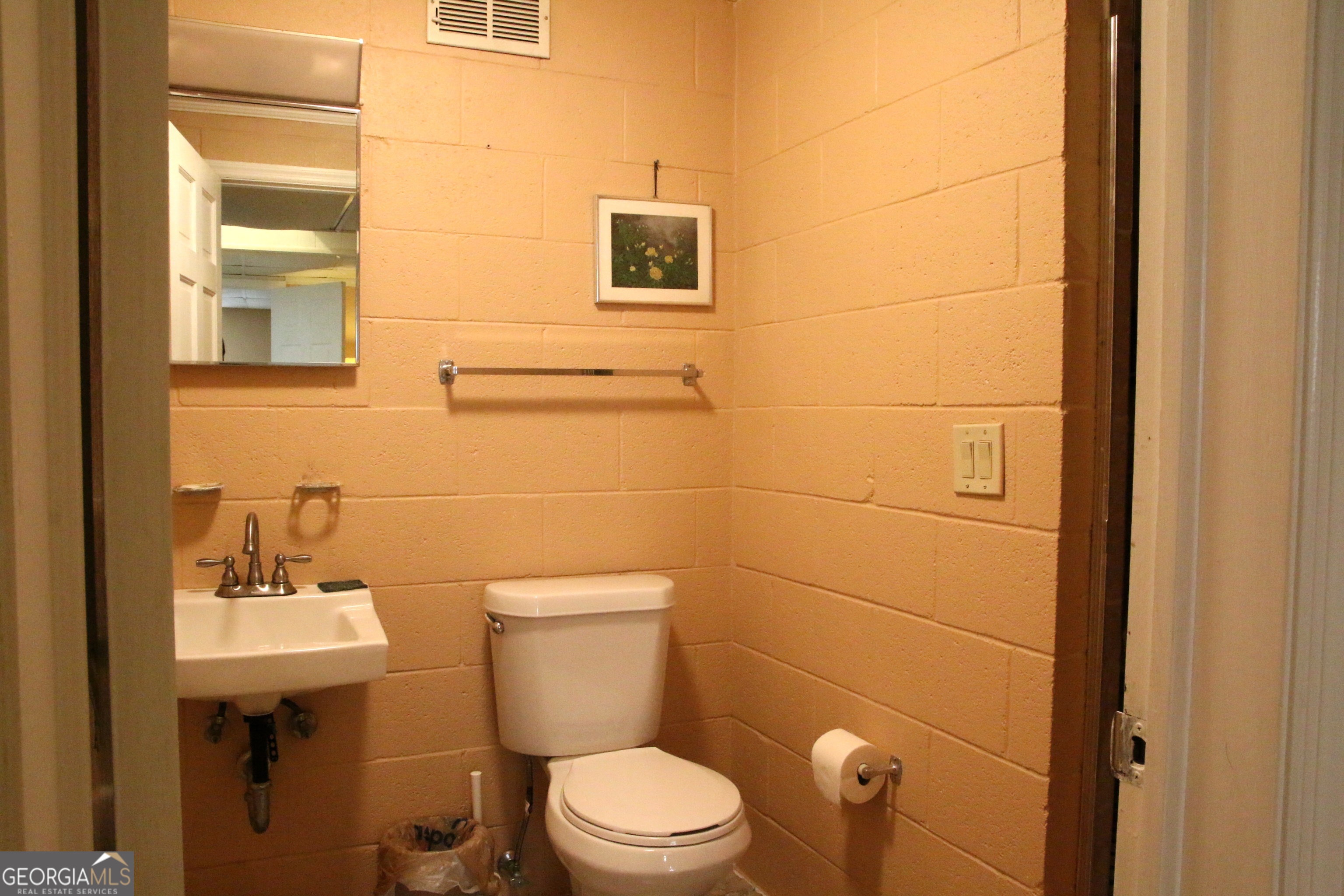 1903 Ridgewood Drive West Point, GA 31833 - Photo 23 of 27 a bathroom with a toilet sink and mirror