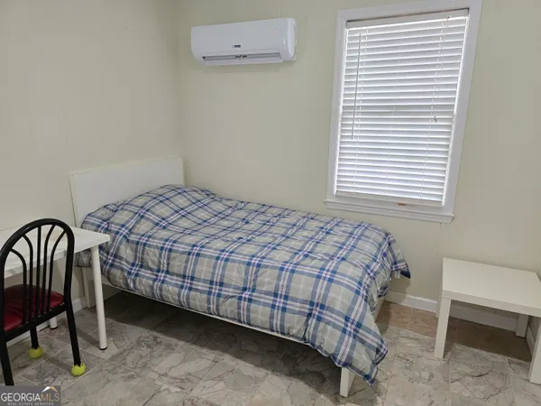 a bedroom with a bed and a bathroom