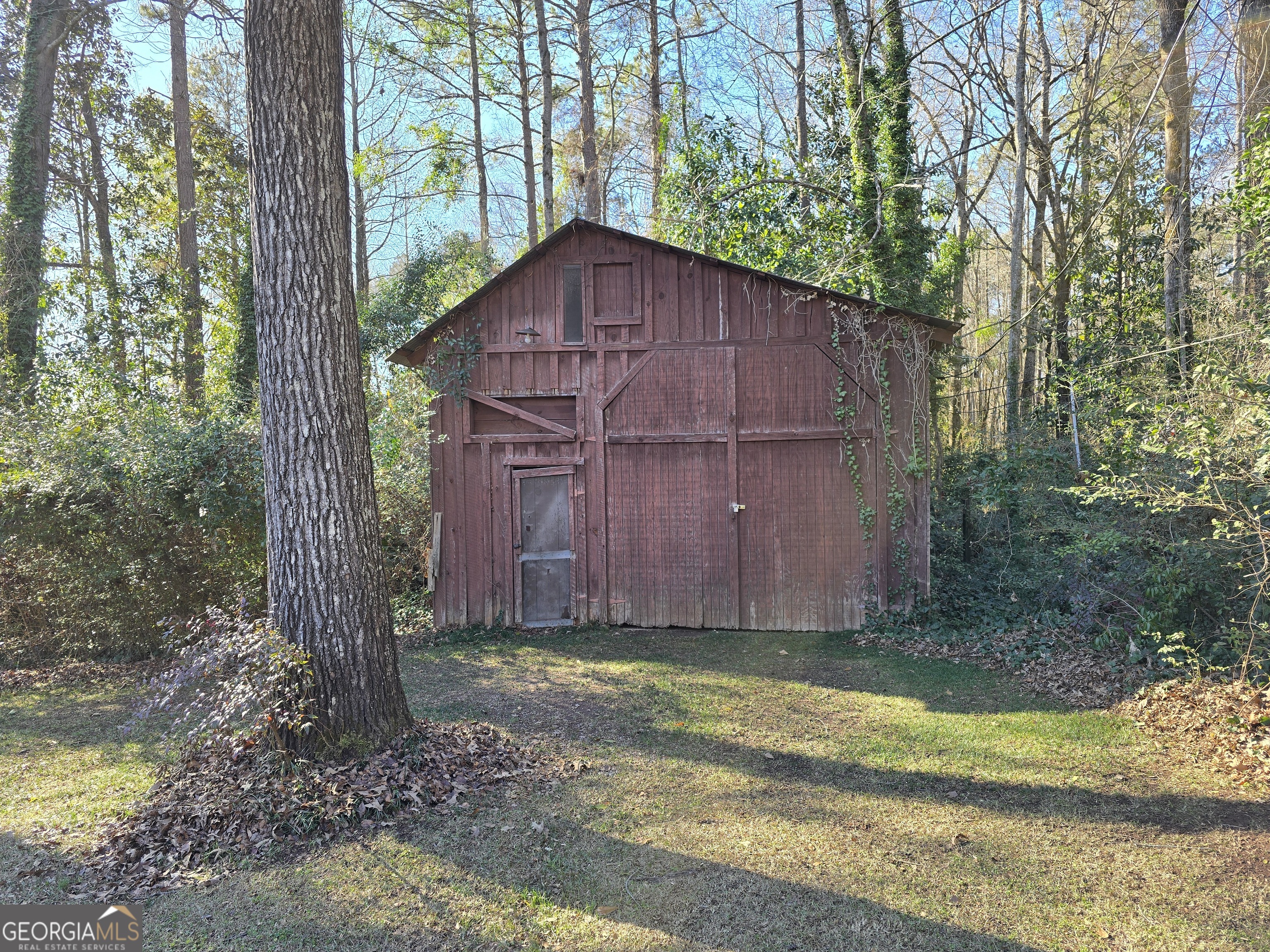 1903 Ridgewood Drive West Point, GA 31833 - Photo 27 of 27 a view of a backyard with plants and large trees
