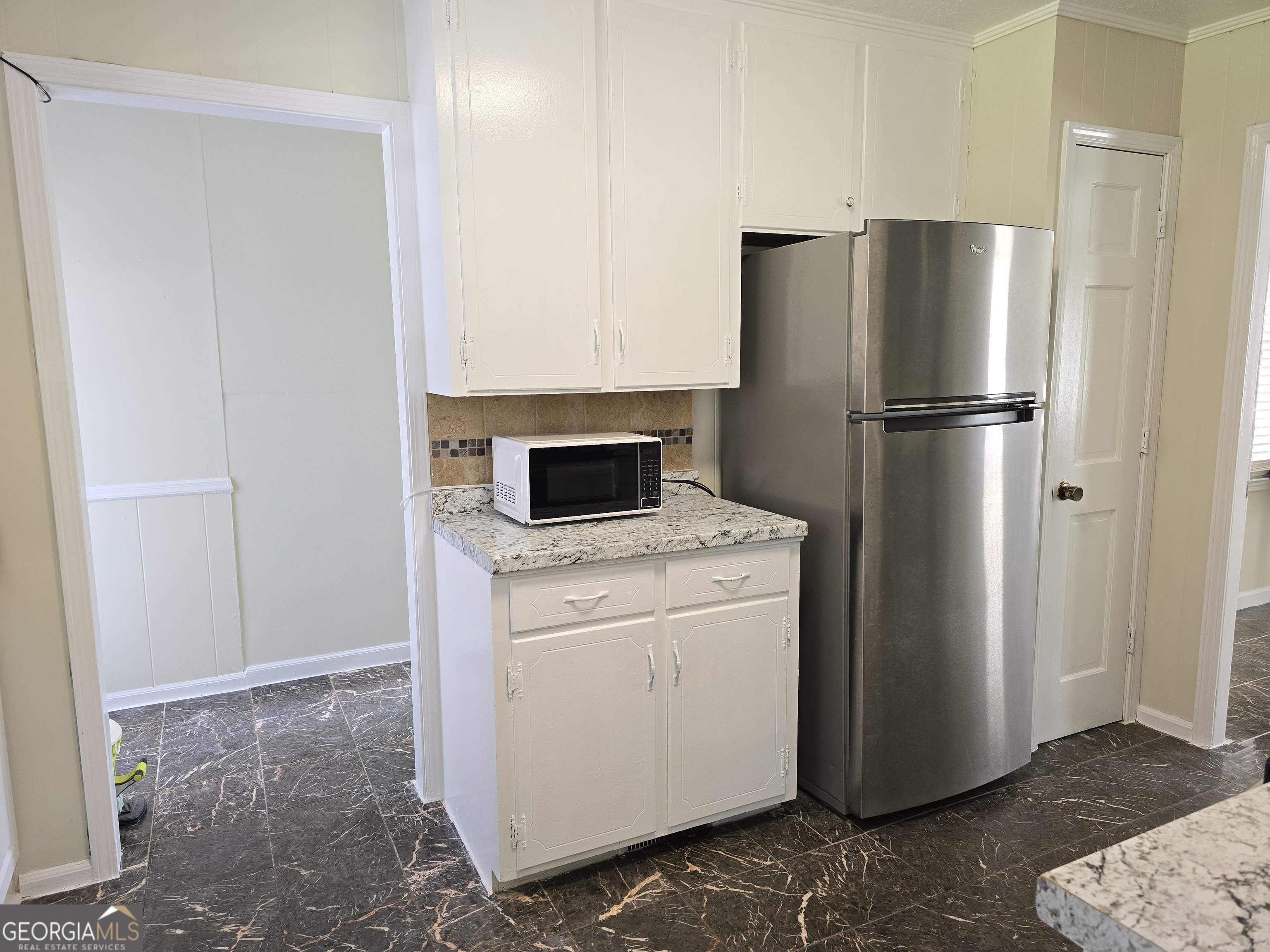1903 Ridgewood Drive West Point, GA 31833 - Photo 10 of 27 a kitchen with a refrigerator and cabinets