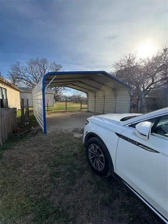 a view of backyard with a car parked