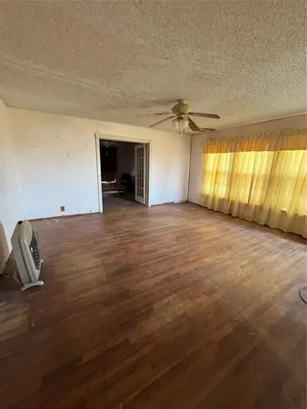 a view of a room with wooden floor and furniture