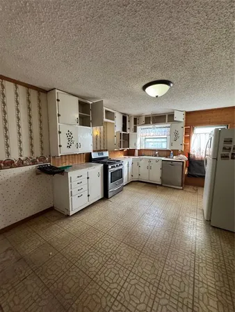 a kitchen with cabinets appliances and a window