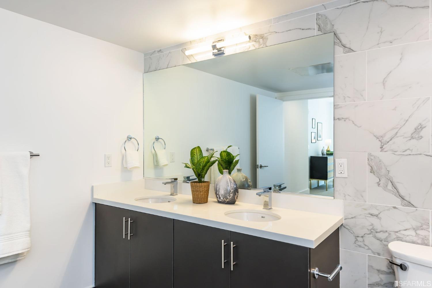 1288 Howard Street, Unit 611 San Francisco, CA 94103 - Photo 14 of 48 a bathroom with a sink and a mirror