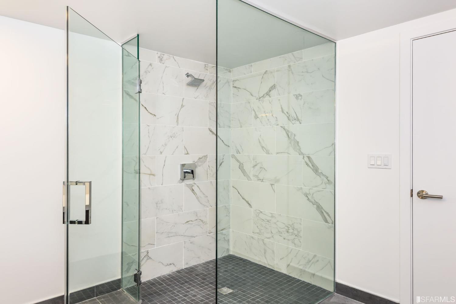 1288 Howard Street, Unit 611 San Francisco, CA 94103 - Photo 15 of 48 a bathroom with a shower and a glass door