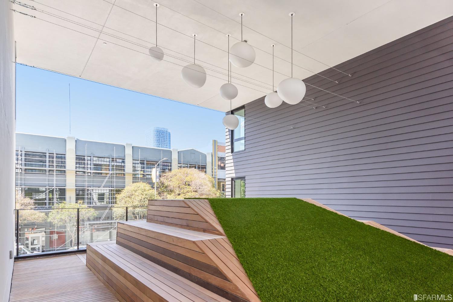 1288 Howard Street, Unit 611 San Francisco, CA 94103 - Photo 19 of 48 a view of a patio with a table chairs and wooden fence