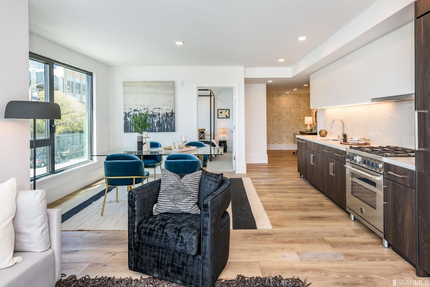 1288 Howard Street, Unit 611 San Francisco, CA 94103 - Photo 3 of 48 a living room with furniture a large window and a rug