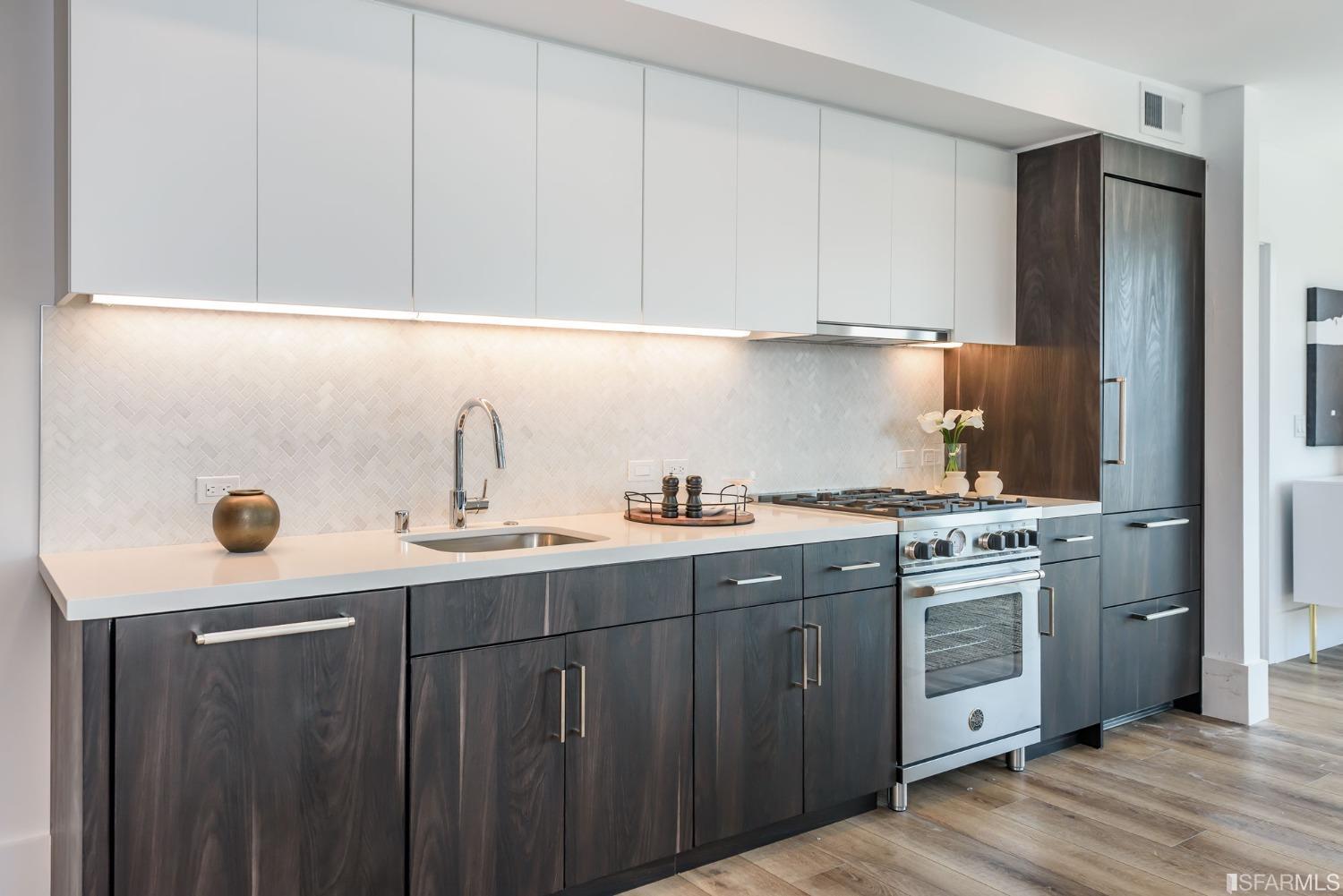 1288 Howard Street, Unit 611 San Francisco, CA 94103 - Photo 5 of 48 a kitchen with a sink cabinets and stainless steel appliances