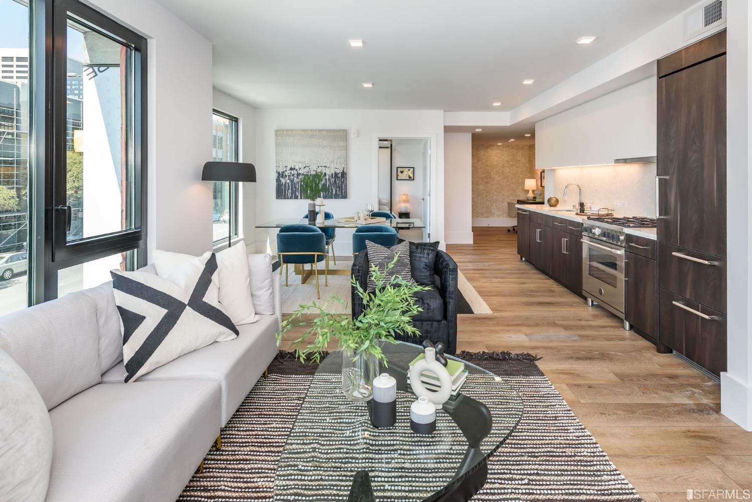 1288 Howard Street, Unit 611 San Francisco, CA 94103 - Photo 6 of 48 a living room with furniture or couch and a dining table
