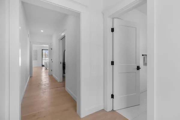 a view of a hallway with wooden floor