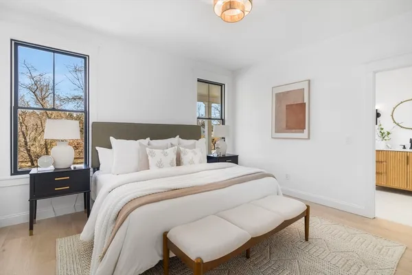 a bedroom with a bed and wooden floor