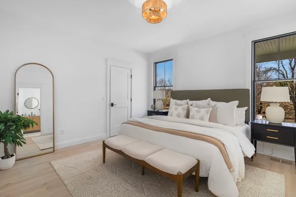 a bedroom with bed and a potted plant