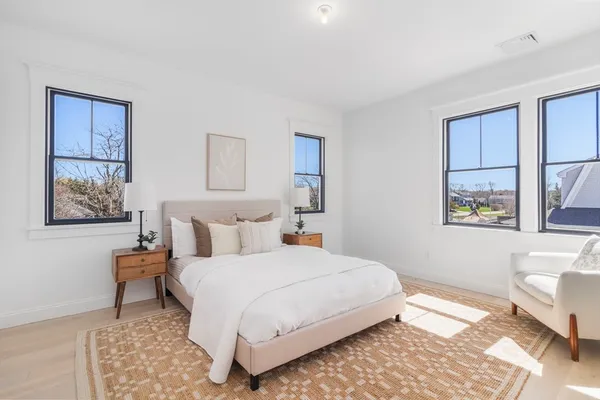 a bedroom with a bed and a painting on the wall