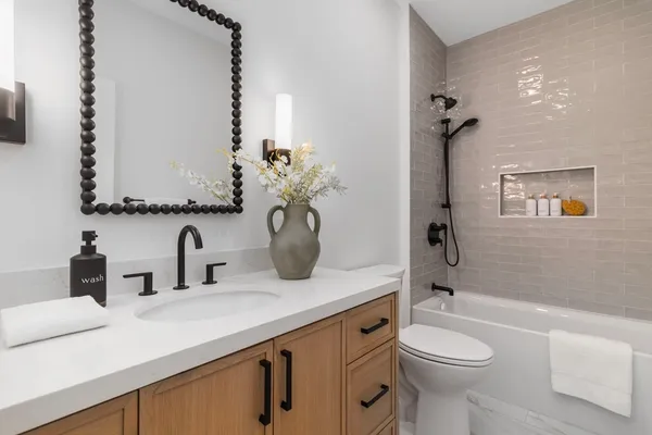 a bathroom with a sink a toilet and shower