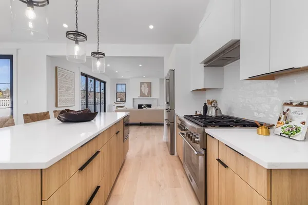 a kitchen with a sink a stove and chairs