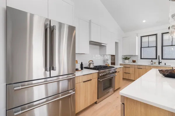 a kitchen with a stove a sink and a refrigerator