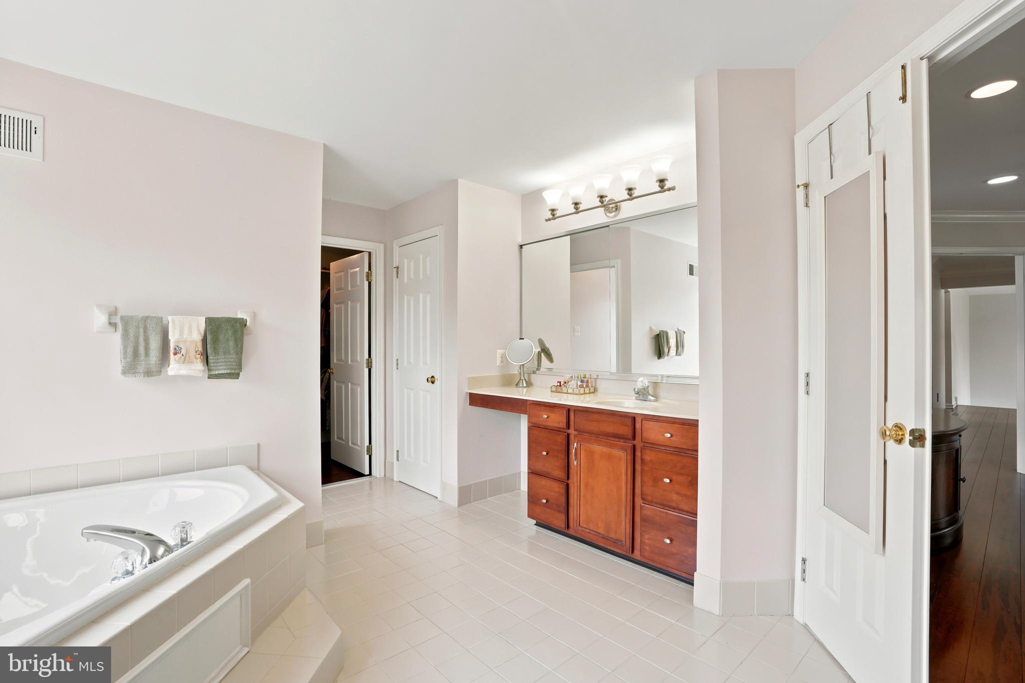 2303 Redtail Road Norristown, PA 19403 - Photo 26 of 53 a spacious bathroom with a double vanity sink a mirror and a bathtub