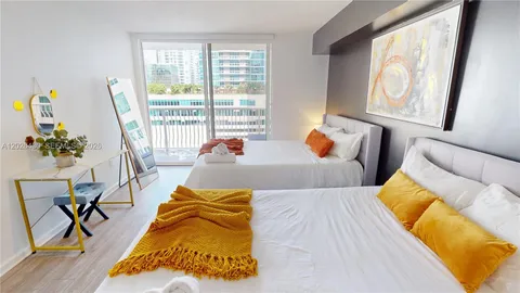 a bed sitting in a bedroom next to a window