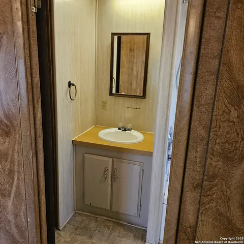 a bathroom with a sink and a mirror