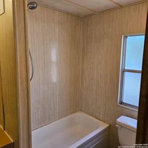 a bathroom with a shower curtain and sink