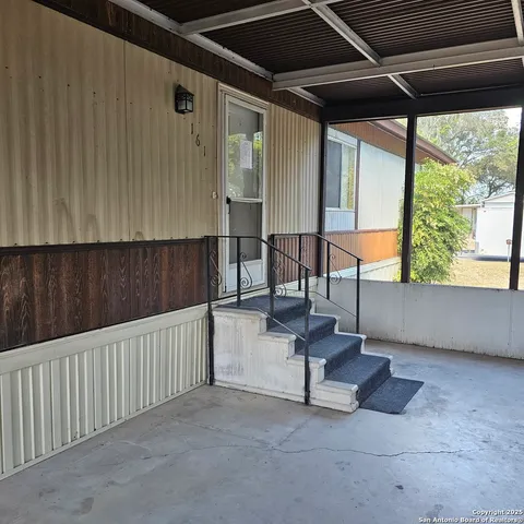a view of an outdoor space with wooden floor