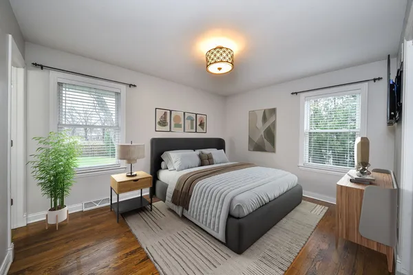 a bedroom with a bed and wooden floor
