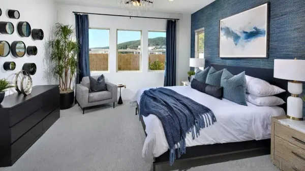 a bedroom with a bed couch and a large window