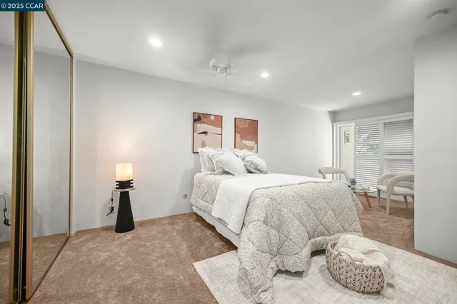 a bedroom with a bed and a large window