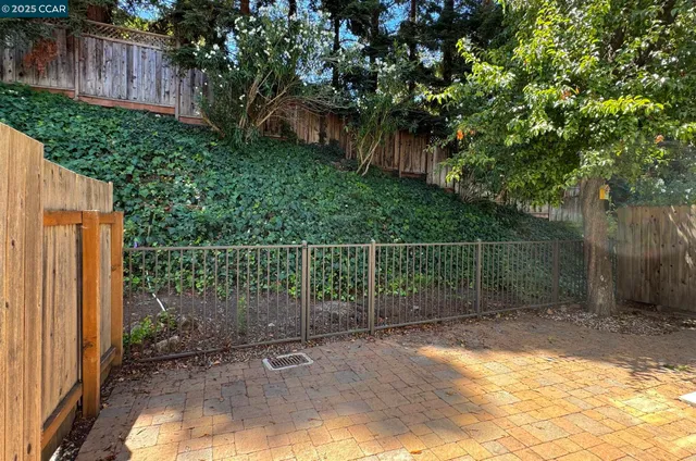 a view of patio with a table and chairs under an umbrella