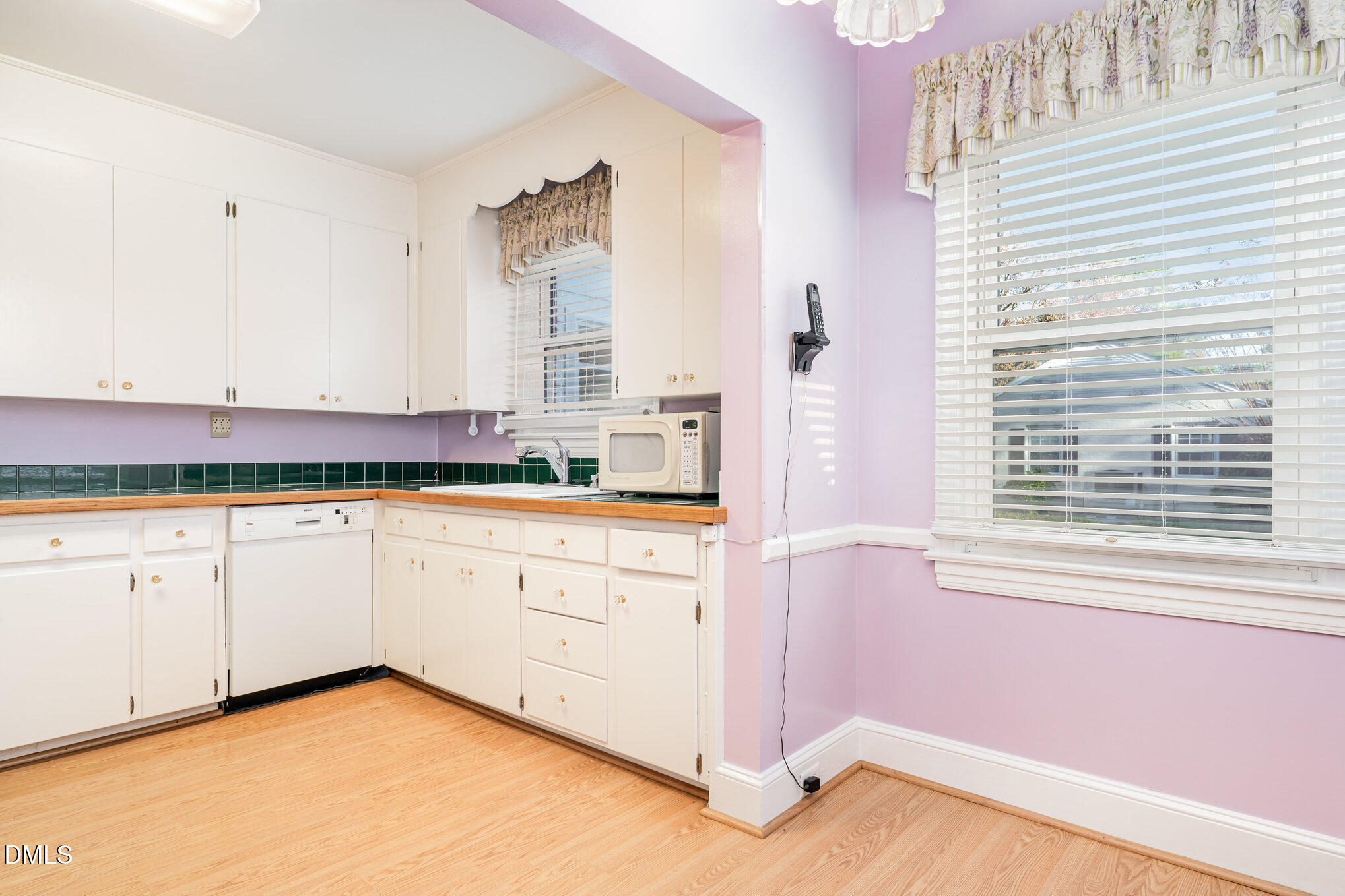 113 West Riverside Drive Smithfield, NC 27577 - Photo 13 of 43 a kitchen with granite countertop white cabinets and white appliances